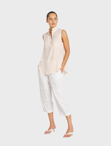 Close-up of white cropped Tuscan pants, emphasizing their clean lines and chic style, perfect for summer fashion.