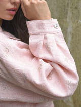 Pink Tweedle Bow Jacket with a unique bow accent, offering a fashionable and whimsical addition to your wardrobe.