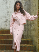 Pink tweed skirt with a classic silhouette, featuring a textured fabric and a stylish design suitable for various occasions.