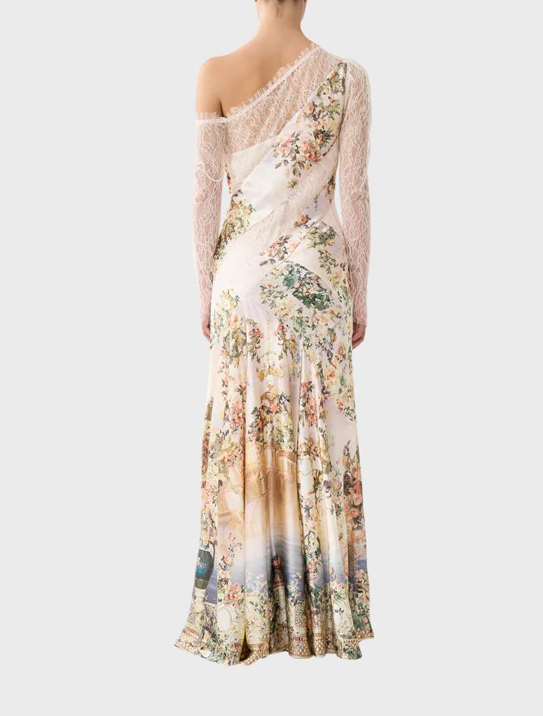 Back view of a woman in a floral print long dress, showcasing the Lace Splice One Shoulder Dress by Twilista.