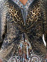 A twist front dress featuring an Istanbul Animalia print, showcasing vibrant colors and a stylish design.