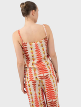 Close-up of an orange Tylis top, emphasizing its color and design details.