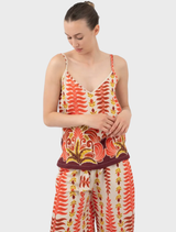 Orange Tylis top presented on a hanger, featuring a contemporary style and vivid hue.