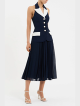 The Ula Midi Dress in navy and white is worn by a model, highlighted by a classic white collar.