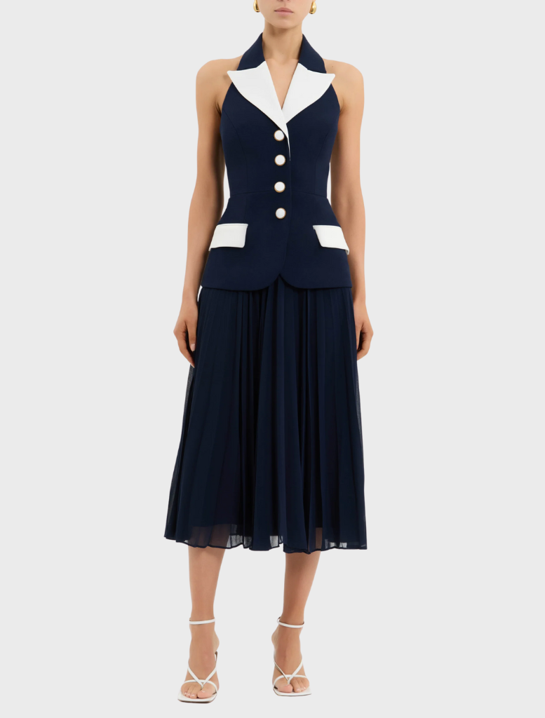 Model wearing the Ula Midi Dress in navy and white, featuring a stylish white collar.