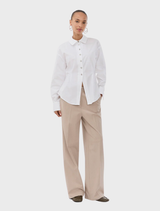 White Ullismd shirt displayed on a hanger against a neutral background.