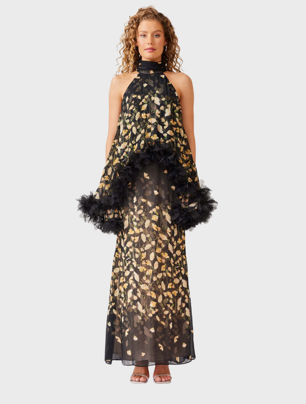 A black and gold floral print dress, showcasing an elegant design with intricate patterns.
