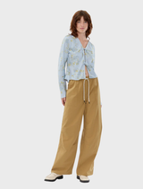 Brown wide trousers with a relaxed fit, featuring side pockets and a drawstring waist for adjustable comfort.