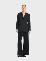 Black utility blazer featuring a tailored fit and functional pockets, ideal for both casual and professional settings.