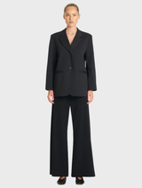 Black utility blazer designed for versatility, combining a structured silhouette with functional elements.