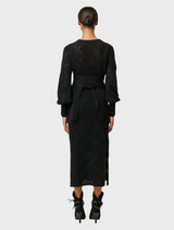 Black V-neck knit dress made from a viscose-cotton blend, featuring a relaxed fit and elegant design.
