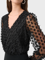 Black wide leg jumpsuit, showcasing a chic and comfortable design suitable for various occasions.