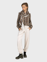 A pair of vanilla-colored barrel trousers, showcasing a modern silhouette with a comfortable, loose fit.