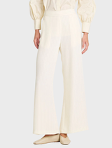 A pair of vanilla and black suit pants laid flat, highlighting their tailored fit and elegant color combination.