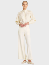 A pair of vanilla and black suit pants laid flat, highlighting their tailored fit and elegant color combination.