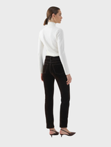 Close-up of chocolate velvet jeans, emphasizing the plush texture and deep hue.
