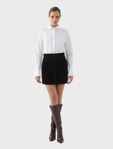 A chocolate-colored velvet mini skirt featuring a luxurious fabric and contemporary cut, ideal for fashionable outfits.