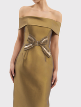 Elegant gold Venus Midi Dress with off-the-shoulder design, diamante bow, fitted bodice, pencil skirt, and back split for comfort.