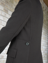 Classic black jacket with a tailored fit, featuring a sleek design and minimalistic style for versatile wear.