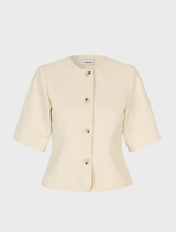 Tailored white blazer with short sleeves, round neckline, and button closure, suitable for both casual and formal occasions.
