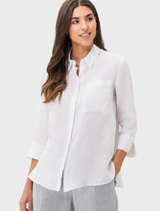 White Vicki linen shirt displayed on a hanger, showcasing its lightweight fabric and casual design.
