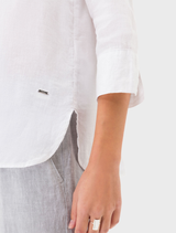  A crisp white linen shirt from Vicki, presented on a hanger, illustrating its casual elegance and comfort.