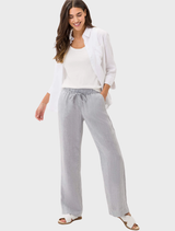 A white linen shirt by Vicki, elegantly hanging, highlighting its soft texture and relaxed fit.