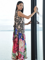 Floral dress featuring a dramatic dip-back, tie detail, and gathered hem for a comfortable, feminine silhouette.