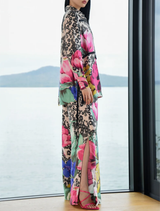 Fluid wide-leg trousers in vintage floral design with side splits, elasticated back, and side pockets for comfort and elegance.