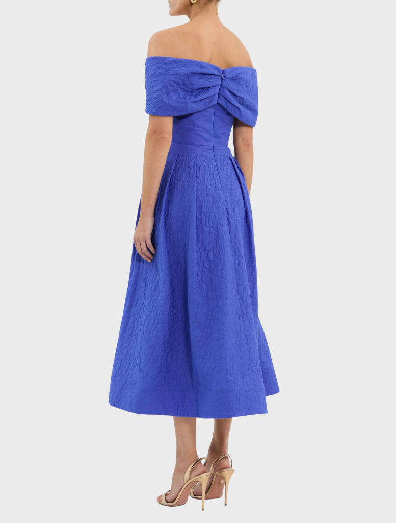 A blue dress with a ruffled neckline, combining sophistication and charm in its design.