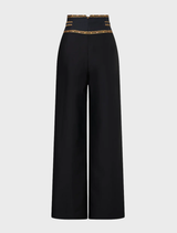 High-waisted tailored pant in silk-wool with waist button detail, inspired by matador costumes and elegant tailoring.