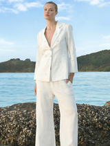 White Walk And Talk Trouser displayed on a hanger, showcasing a sleek and modern design suitable for casual or formal wear.