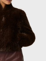 Trendy cropped jacket in walnut faux fur, showcasing a soft, plush design suitable for fashionable layering in autumn.