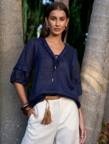 Romantic indigo blouse featuring a deep V neckline, short blouson sleeves, and artisanal raw bias strips at seams.