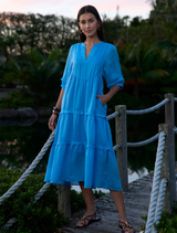 Bluebell waterlily dress featuring a V-neck, full sleeves, tiered design, and discreet side seam pockets for added convenience.