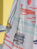 A woman's skirt adorned with a sailboat pattern, named "Don't Make Waves Dress - Marina.