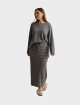 Stylish pleat skirt in ash, made from Merino cotton, offering comfort and sophistication for any wardrobe.