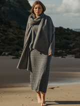 Ash-colored pleat skirt made from Merino cotton, featuring a flowing design suitable for casual or formal occasions.