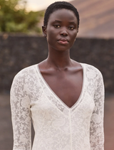 Elegant off-white lace dress featuring a V-neck, long sleeves, and a flounce hem, ideal for bohemian chic occasions.