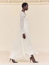 Long off-white jacquard lace dress with V-neck, long sleeves, and gathered flounce hem, perfect for summer occasions.

