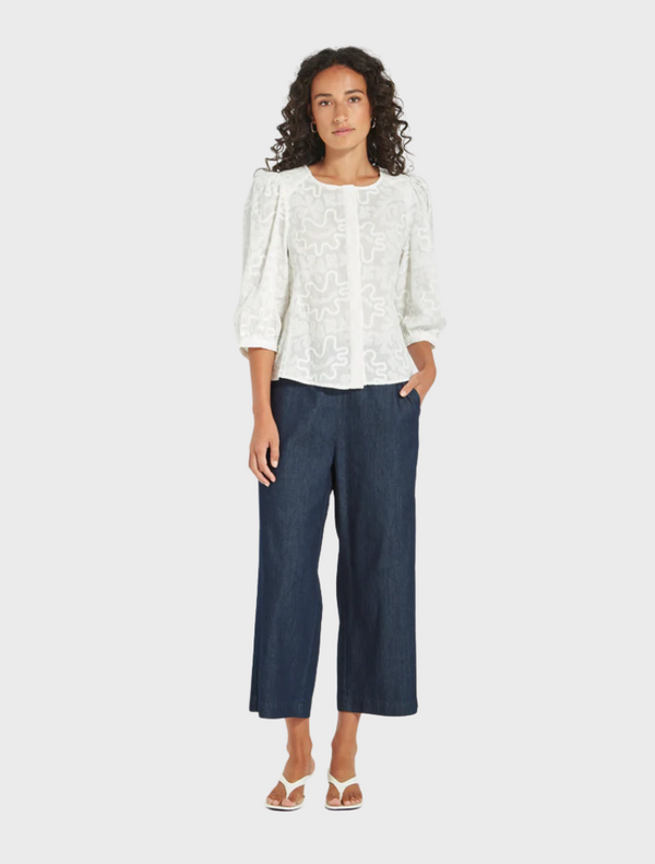 A pair of cropped wide leg pants made from denim, highlighting their modern and relaxed fit.