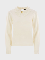 White macrame lace knit fabric with a delicate, intricate pattern, showcasing a soft and elegant texture.