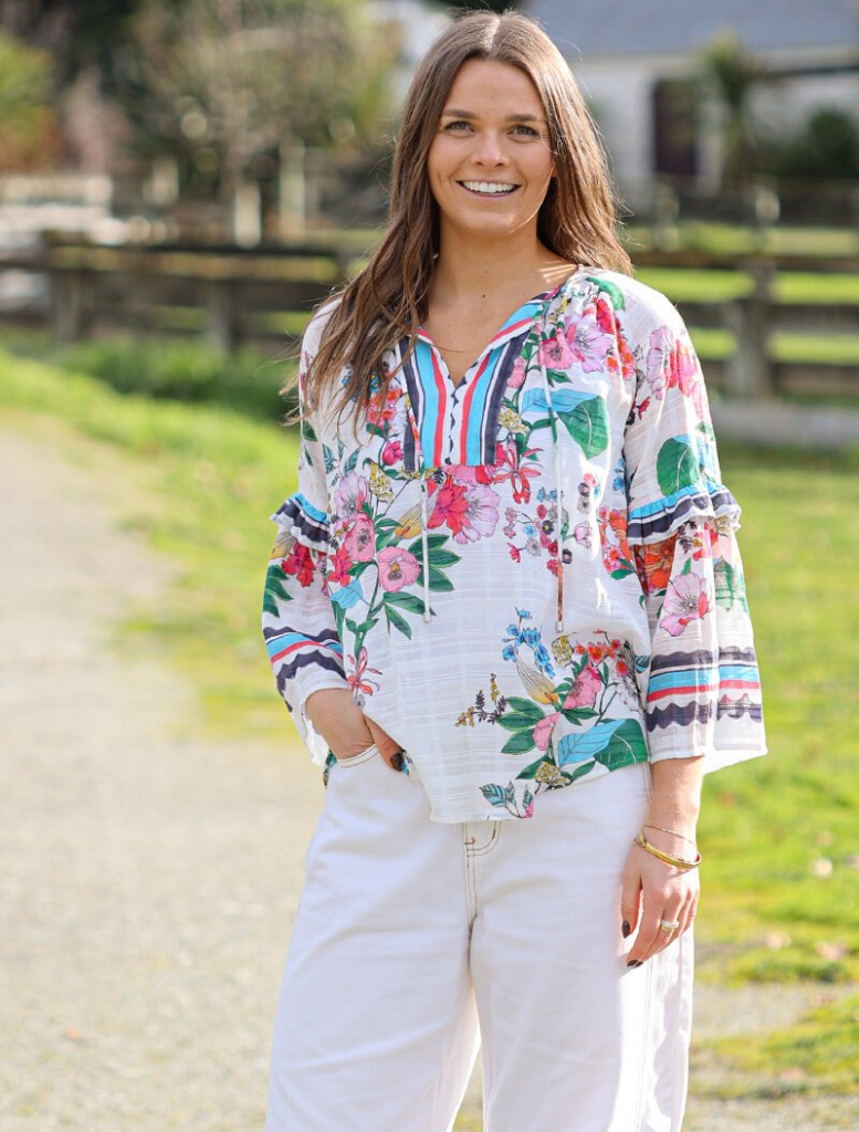 White floral dress with long sleeves and a ruffled skirt, identified as Pandora Blouse - White Multi.