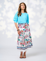  The Pandora Skirt - White Multi features a floral pattern in white and blue, crafted from a comfortable cotton blend.