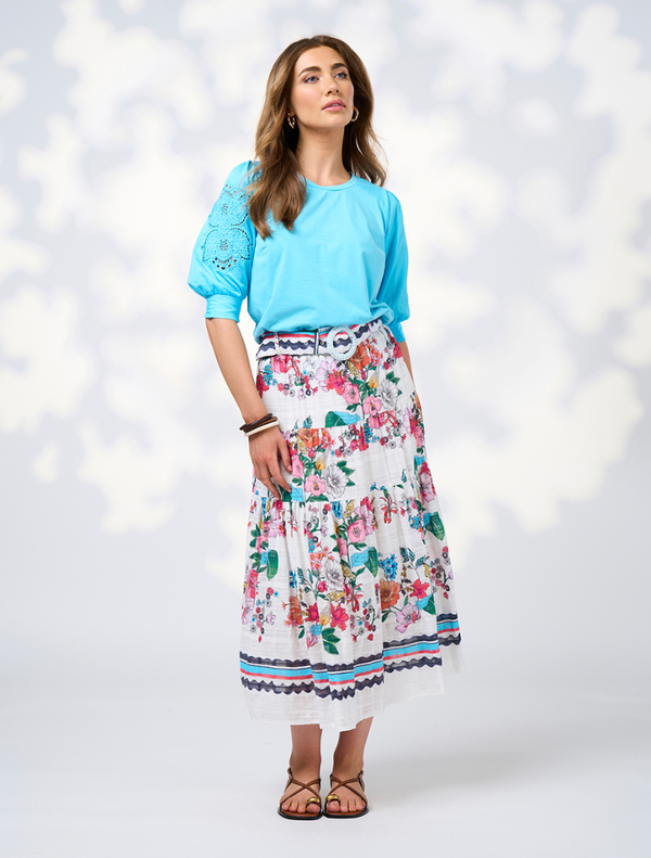  The Pandora Skirt - White Multi features a floral pattern in white and blue, crafted from a comfortable cotton blend.