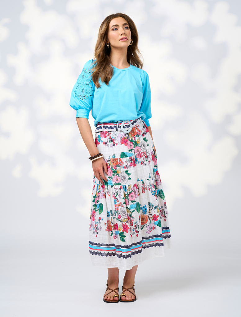  The Pandora Skirt - White Multi features a floral pattern in white and blue, crafted from a comfortable cotton blend.