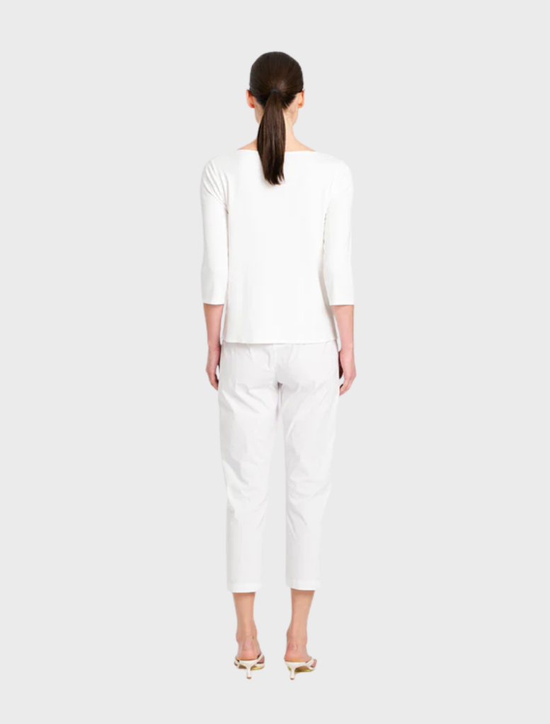 Close-up of a white relaxed boat neck top, emphasizing its smooth texture and laid-back aesthetic.