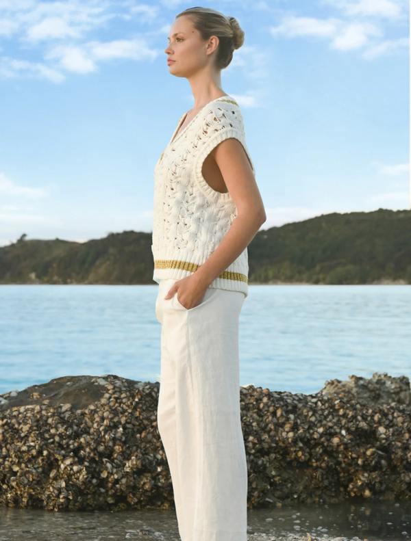 A pair of white Walk And Talk Trousers laid flat, featuring a tailored fit ideal for both comfort and style in various settings.