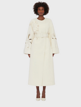 White wool coat with long sleeves and a belt, perfect for stylish warmth in cooler weather.