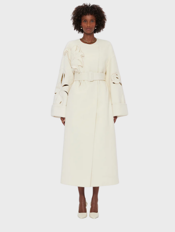 White wool coat with long sleeves and a belt, perfect for stylish warmth in cooler weather.